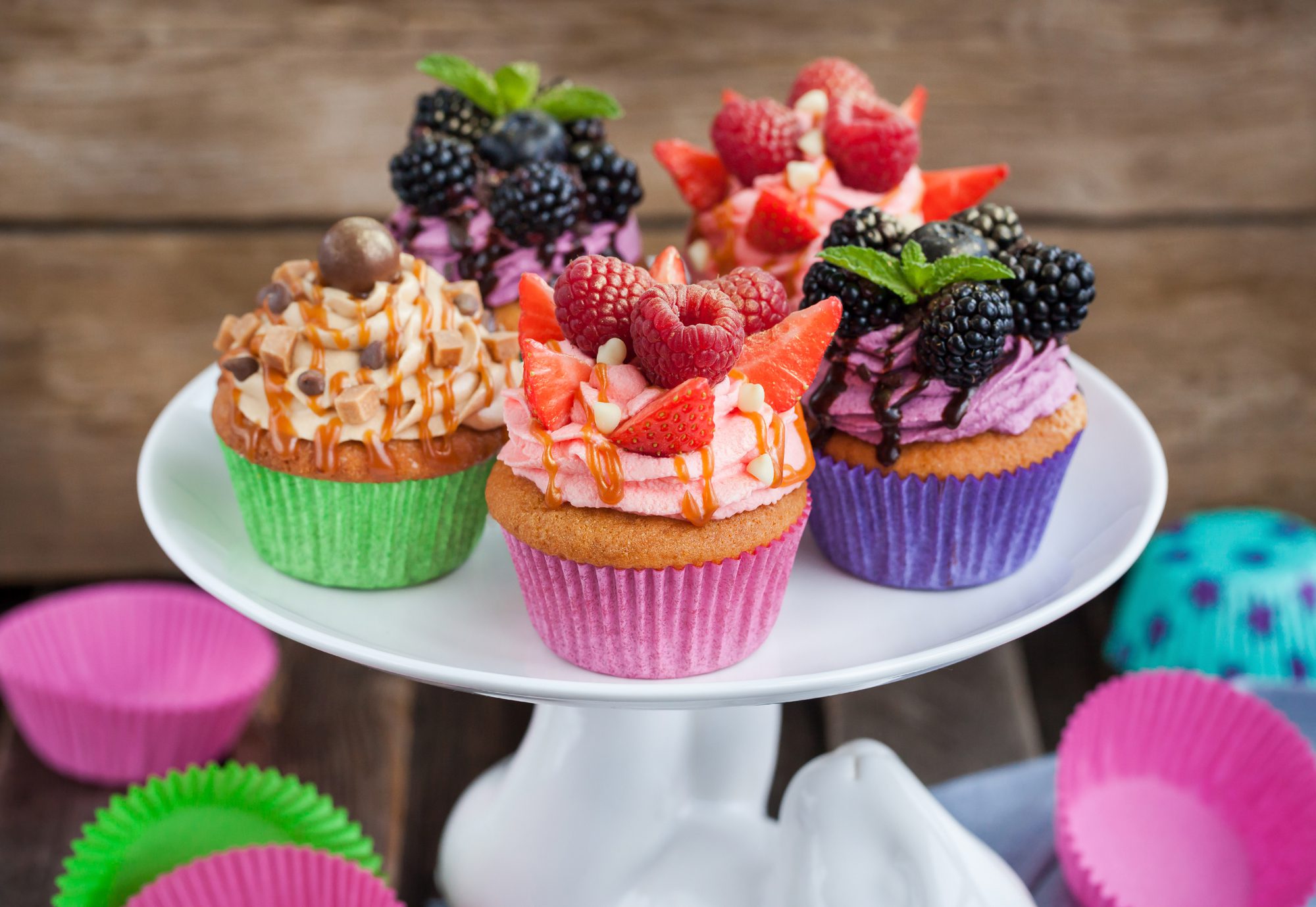 A decorative cake stand showcasing a variety of cupcakes