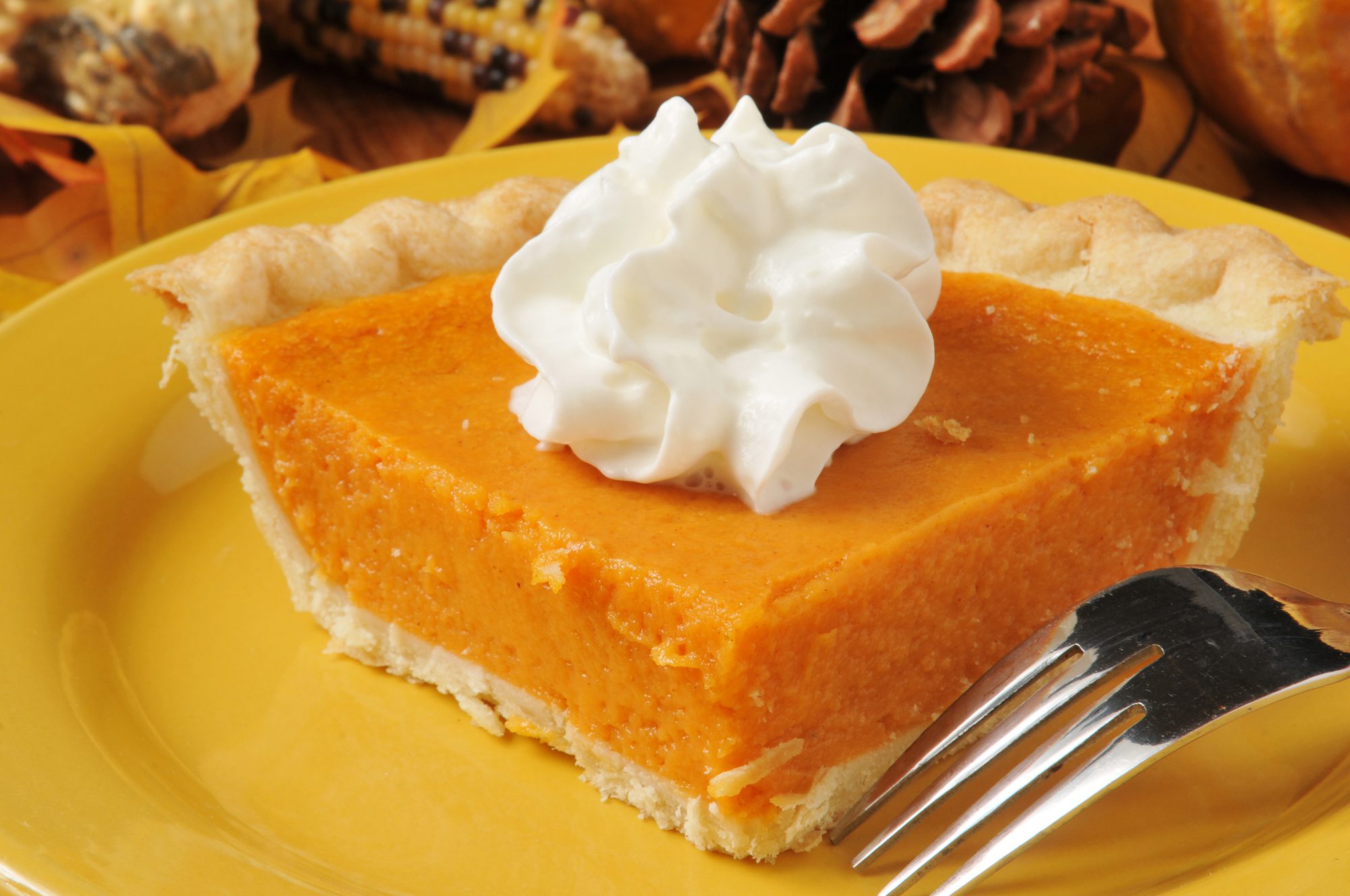 A slice of dessert pie on a bright yellow plate